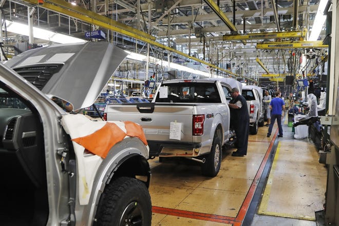 United Auto Workers assemblymen work on a 2018 Ford F-150 trucks being assembled at the Ford Rouge assembly plant in Dearbor. [AP FILE]