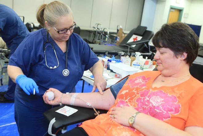 Lisa Berkner, Tech III of the American Red Cross, prepares to draw blood from donor Lisa Railing at a 2015 blood drive. Two blood drives are being held soon at the YMCA to help with a severe shortage due to the coronavirus pandemic. [John Althouse/The Daily News]