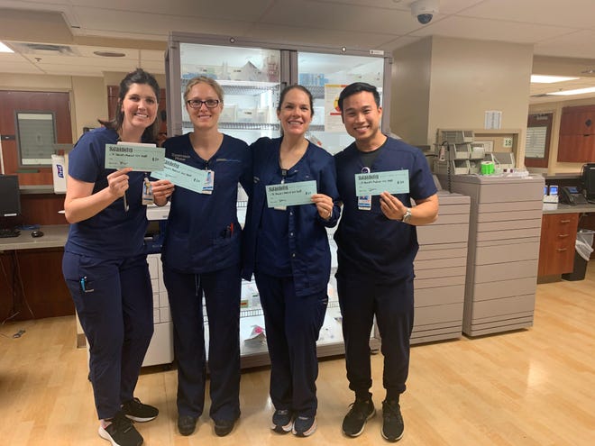 Staff members at St. David’s Medical Center pose with their gift certificates to Sala & Betty. A GoFundMe campaign allows people to donate meals to hospital staff from local restaurants. [Contributed by Hope Costanzo]