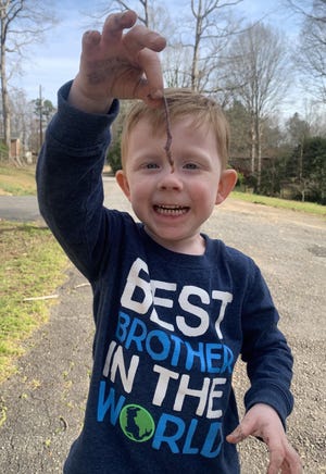 Cole Howell’s holding his first earthworm and he is so proud! Nothing like dirty hands and spending Saturday with your great grandpaw - Phillip Carr in Stanley. [PHOTO BY Cynthia Carr-Beasley]