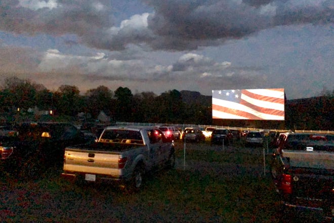 Opening night at Hound’s Drive-In in Kings Mountain started with the national anthem. [MICHAEL BANKS/THE GASTON GAZETTE]