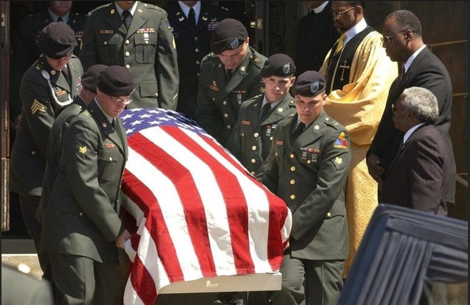 The flag-draped coffin of Pfc. Brandon U. Sloan is carried to a hearse after a funeral service Saturday, April 12, 2003, at Historic Greater Friendship Baptist Church in Cleveland. Sloan, 19, of suburban Bedford Heights, was part of a convoy of the 507th Maintenance Company, ambushed by Iraqi forces near Nasiriyah on March 23. (AP Photo/Tony Dejak)