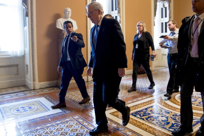 Senate Majority Leader Mitch McConnell of Ky. arrives on Capitol Hill in Washington on Monday as the Senate is working to pass a coronavirus relief bill. [AP Photo/Andrew Harnik]