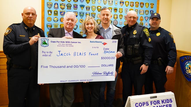 Pictured at a Cops for Kids with Cancer check presentation of $5,000 to Jacob Blais are Saugus Interim Police Chief Ronald Giorgetti, Cops for Kids with Cancer Board of Directors member Edward McNelley, Kerry Blais, Brian McCormack (friend), Sgt. James Harkins of Peabody and Saugus Police Sgt. Shawn Flynn, who is president of the Saugus Police Superior Officers Association. Courtesy photo
