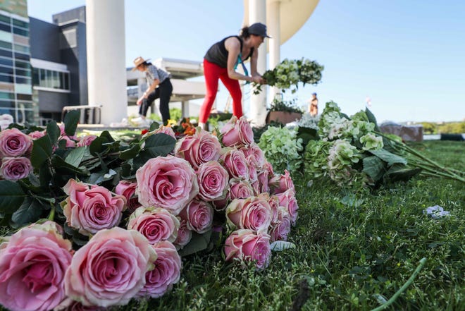 A group of floral designers partnered with the Long Center to create a giant floral piece on the Long Center terrace on Tuesday. [LOLA GOMEZ / AMERICAN-STATESMAN]