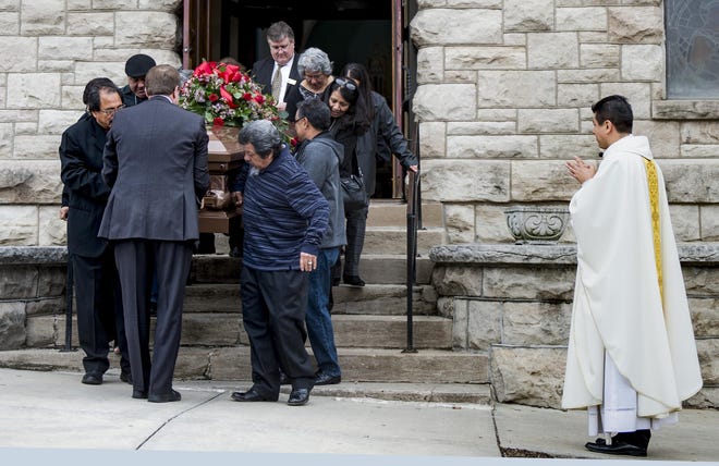 Family members carried the casket of Albert 'Tic Toc' Tinoco out of Sacred Heart Guadalupe church after his funeral Monday in Kansas City. The COVID-19 restrictions allowed only 10 members of the family to attend the funeral, which normally would have have drawn 1,500 people. [Tammy Ljungblad/The Kansas City Star via AP]