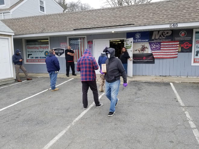 Customers were waiting outside the Shooting Supply gun store on Route 6 in Westport, which like many gun stores, has seen a run on on ammunition and gun purchases since the coronavirus outbreak. [CURT BROWN/THE STANDARD-TIMES/SCMG]