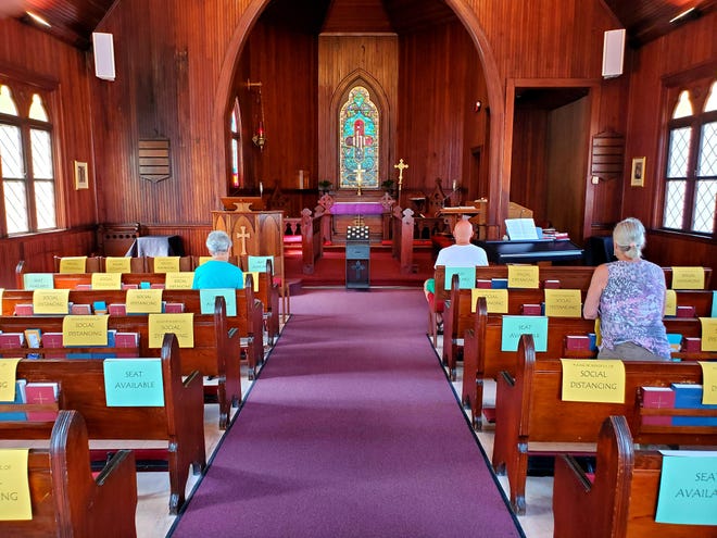 Visitors to St. Cyprian's Episcopal Church in Lincolnville are seen praying in the sanctuary on Monday. [COLLEEN JONES/THE RECORD]