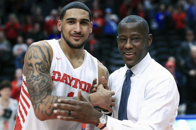 Dayton's Obi Toppin, left, celebrates scoring his 1,000th career point with head coach Anthony Grant, right, after a game against Duquesne on Feb. 22 in Dayton, Ohio. (AP Photo/Aaron Doster)