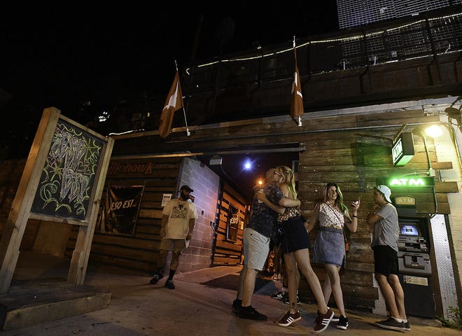 Samson Kanter, center left, gets a hug from Soledad Fernandez, center right, in front of Mohawk on Saturday August 31, 2019, at 912 Red River Street. [STEVE LEWIS for AMERICAN-STATESMAN]
