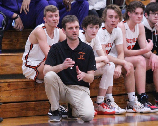 Jonesville boys basketball coach Kirk Wright and his bench survey the court during their district semifinal against Hanover-Horton at Concord High School on March 11. On Wednesday, the Jackson County Health Department issued a warning that the district tournament game was a probable site for COVID-19 exposure. Sam Fry/Daily News File Photo