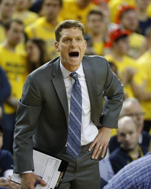 Michigan assistant coach Luke Yaklich gives instructions in the first half of an NCAA college basketball game against Penn State in Ann Arbor, Mich., Thursday, Jan. 3, 2019. (AP Photo/Paul Sancya)