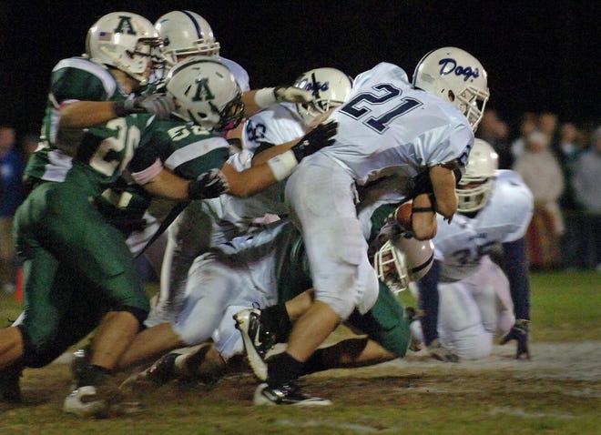 Rockland’s Tim Fitzgerald (21) and the rest of the Rockland defense stops Abington ball carrier Dylan Pietrasik during the infamous ‘Nuts and Bolts Game’ on Oct. 22, 2010. (Amelia Kunhardt/The Patriot Ledger)
