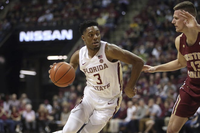 Florida State's Trent Forrest, left, works the ball upcourt against the defense of Boston College's Luka Kraljevic in the first half of an NCAA college basketball game Saturday, March 7 2020, in Tallahassee, Fla. (AP Photo/Steve Cannon)