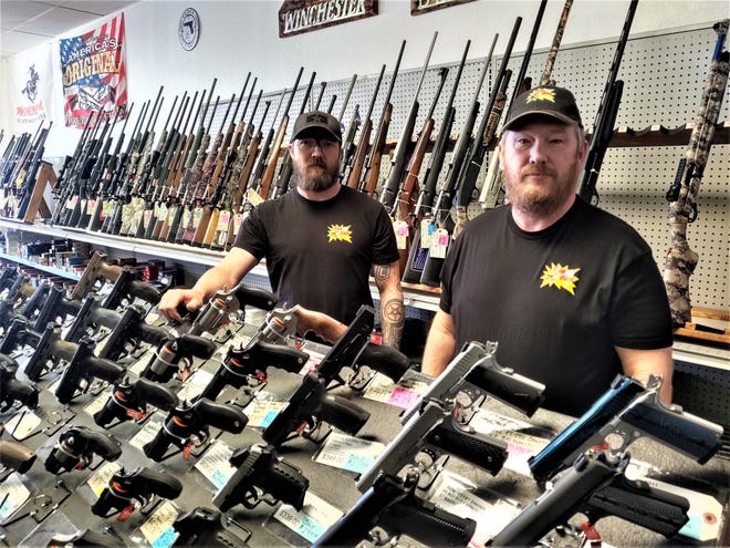 Bam Bam Firearms and Sporting Goods manager David Weaver, left, and owner Greg Collins, say sales have skyrocketed in the wake of the coronavirus scare. [CHIEFTAIN PHOTO/JON POMPIA]