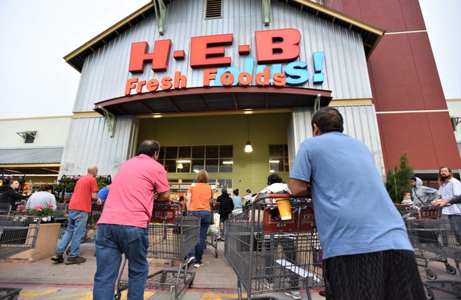 Shoppers line up at Bastrop H-E-B before an 8 a.m. opening on Sunday. The store compressed its hours of operation to give staff additional time to stock products which are selling out quickly amid the novel coronavirus pandemic. [TERRY HAGERTY/ FOR BASTROP ADVERTISER]