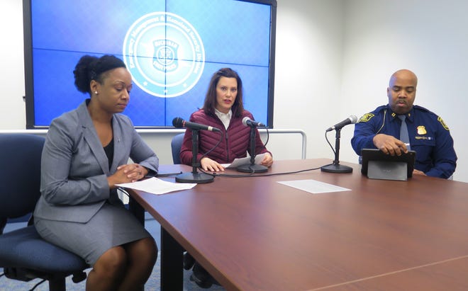 Michigan Gov. Gretchen Whitmer, center, announces the state's first two cases of coronavirus, Tuesday, March 10, 2020, at the Michigan State Police headquarters in Windsor Township, Mich. At left is Dr. Joneigh Khaldun, the state's chief medical executive, and at right is Capt. Emmitt McGowan, deputy state director of emergency management and homeland security (AP Photo/David Eggert)
