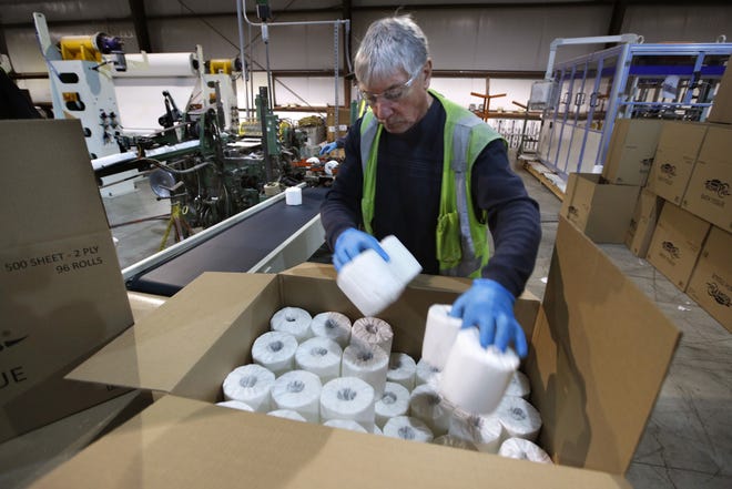 Scott Mitchell fills a box with toilet paper at the Tissue Plus factory in Bangor, Maine. The new company has been unexpectedly busy because of the shortage of toilet paper brought on by hoarders concerned about the coronavirus. [AP Photo/Robert F. Bukaty]