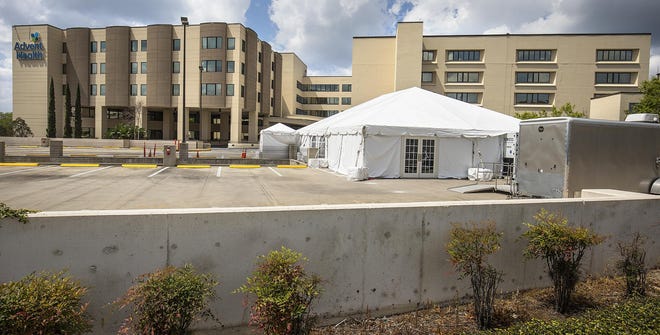 AdventHealth Ocala has erected an air-conditioned tent on top of the parking structure for overflow space, if needed. [Doug Engle/Staff photographer]