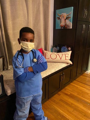 Antonio Cole, 8, of Plymouth, dress as his grandfather, Gary, for Superhero Day at school. Gary Cole is an emergency department physician at Carney Hospital in Dorchester. (Cole Family)