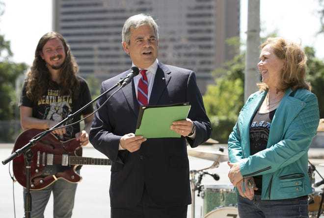 Ty Richards, left, and HAAM executive director Reenie Collins, right, listen as Mayor Steve Adler reads a proclamation declaring HAAM Day at Austin at City Hall during HAAM Benefit Day in 2017. The organization provides low-cost health care to members of the Austin music community. [JAY JANNER / AMERICAN-STATESMAN]