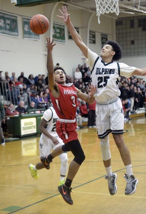 Dennis-Yarmouth's Alex Stowe, named Cape & Islands Atlantic MVP, reaches to block a shot by fellow C&I All-Star J'Adaro France of Barnstable during a game in South Yarmouth on Jan. 17. [Ron Schloerb/Cape Cod Times]