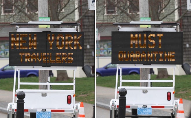 A sign stationed on Broadway in Newport instructs visitors from New York to self-quarantine. [SCOTT BARRETT/DAILY NEWS PHOTO]