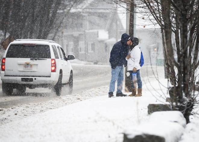 FITCHBURG - A couple leans in for a quick kiss while walking in the snow on Westminster Street during the storm on Monday, December 30, 2019. [T&G Staff/Ashley Green]