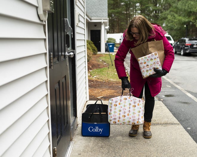 Regina Kruger of Shrewsbury, delivers a birthday cake and presents for her daughter, Megan, who turned 18 on Wednesday. Megan lives in a group home and social isolation has been particularly difficult at this time. [T&G Staff/Ashley Green]