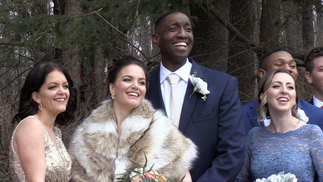 Karla and Joseph Chery (center) pose for wedding pictures on March 14. [Brian Vernellis/Sentinel Staff]