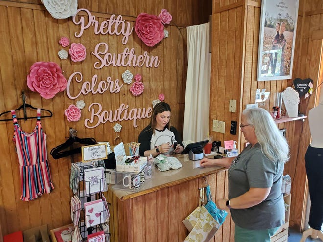 Owner of Pretty Southern Colors Boutique, Anna Spangenberg, left, and her mother Rose Marie Frigm check inventory at the store on Saturday. Spangenberg has been hosting sales with curbside pickups to help bring in revenue during the coronavirus threat. [Trevor Dunnell / The Daily News]