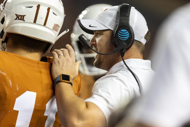 Texas coach Tom Herman speaks with quarterback Sam Ehlinger during a timeout in a game last season. Both have stepped up with fundraising and donation efforts during the coronavirus pandemic. [STEPHEN SPILLMAN/FOR STATESMAN]
