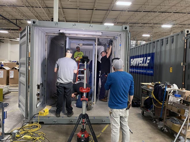 Workers at Battelle's West Jefferson facility build one of its Critical Care Decontamination Systems, which Battelle says can sterilize 80,000 masks per day.