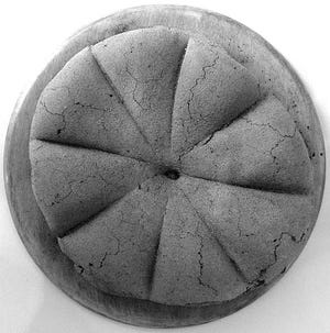 Ancient Roman fossilized bread from Pompeii, first century A.D.; National Archaeological Museum, Naples, Italy. [Beatrice/Wikimedia Commons]