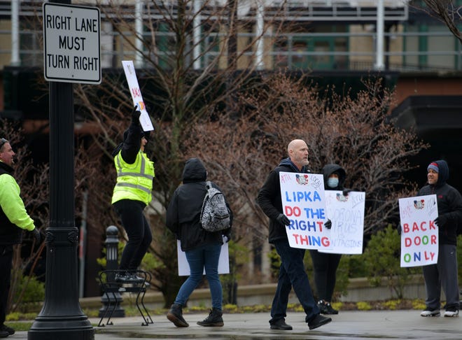 Bus drivers hold signs outside the WRTA hub at Union Station in Worcester on Monday. The drivers are pushing management for improved conditions during the COVID-19 pandemic. [T&G Staff/Christine Peterson]