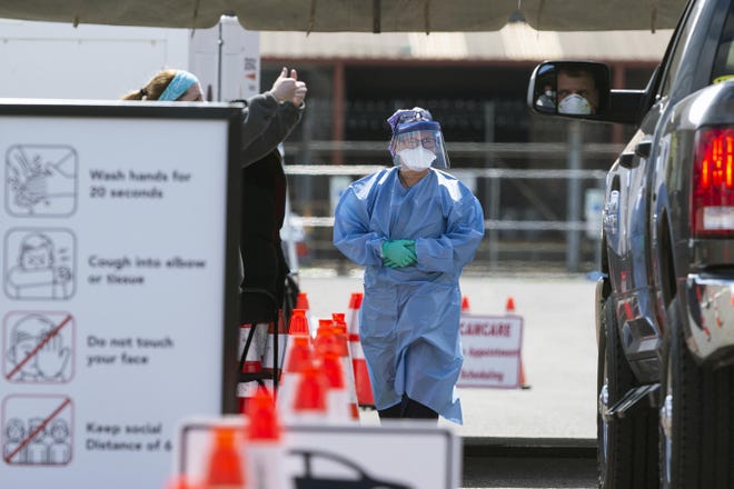 Healthcare professionals work a COVID-19 testing site Wednesday in Camden. [JOE LAMBERTI / COURIER-POST]