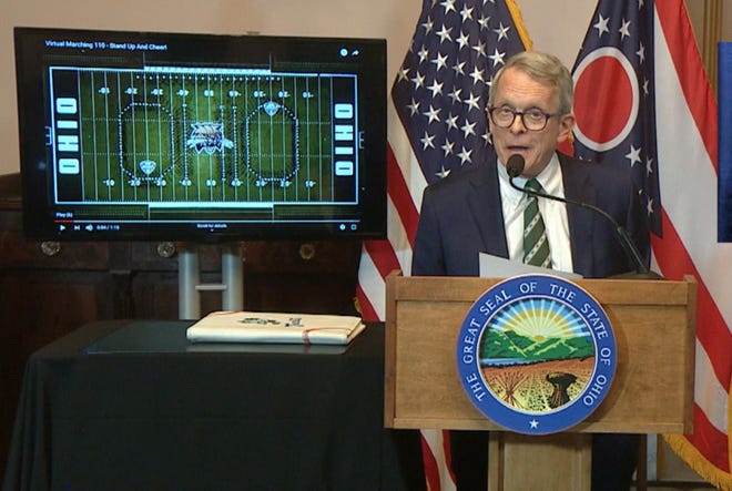 Ohio Gov. Mike DeWine introduces the Ohio University Marching Band at the end of his Tuesday, March 31, 2020 news conference.