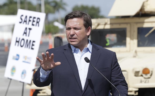 Florida Gov. Ron DeSantis speaks during a news conference at a drive-through coronavirus testing site in front of Hard Rock Stadium, Monday, March 30, 2020, in Miami Gardens. [AP Photo/Wilfredo Lee]