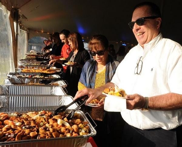 Marie and Rob Correia enjoy conversation and the buffet at Day of Portugal in 2017. [Herald News file photo]