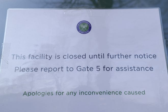 A sign outside one of the main gates to Wimbledon as it is announced that the The Championships for 2020 have been canceled due to the coronavirus. (AP Photo/Kirsty Wigglesworth)