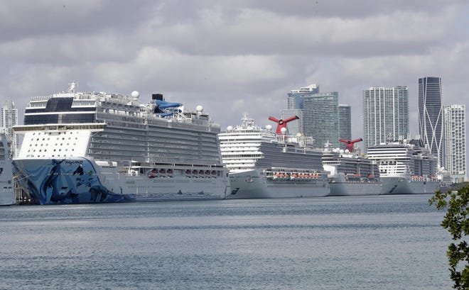Cruise ships are shown docked at PortMiami, Tuesday, March 31, 2020, in Miami. (AP Photo/Wilfredo Lee)