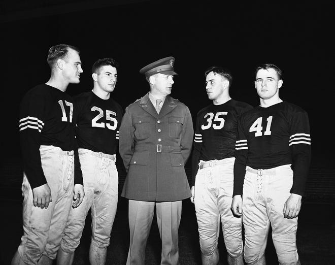 Members of the Army football team, from left, Thomas McWilliams, Arnold Tucker, Col. Earl Blaik (coach), Felix Blanchard and Glenn Davis, are shown at the United States Military Academy in West Point, N.Y. in 1945. (AP Photo/File)