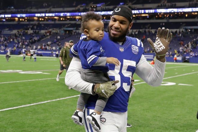 FILE - In this Nov. 11, 2018, file photo, Indianapolis Colts tight end Eric Ebron (85) carries his son as he leaves the field following an NFL football game against the Jacksonville Jaguars in Indianapolis. Ebron is embracing a fresh start in Pittsburgh after an ugly divorce with the Indianappolis Colts. The Steelers signed Ebron to a two-year contract last week. (AP Photo/Darron Cummings, File)