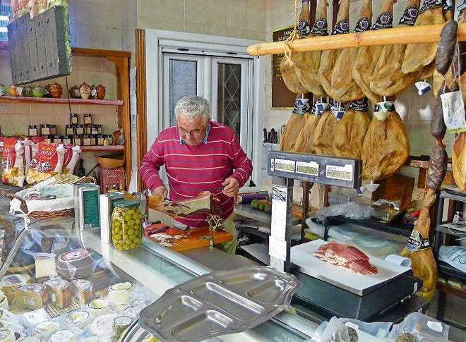 Some of the finest Andalusian ingredients are available at the Lanjaron market, including local ham from Santiago’s jamoneria. [ARI LEVAUX]