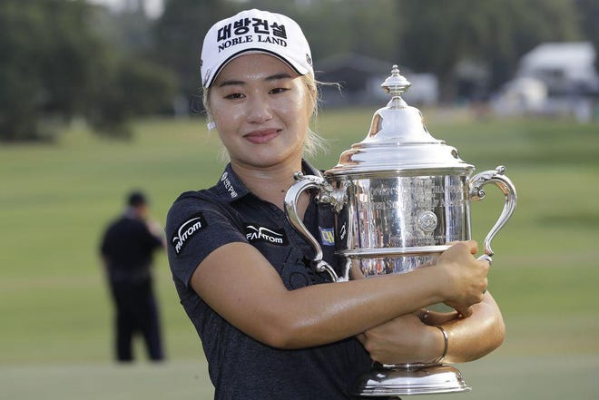 Jeongeun Lee6 of South Korea, holds the championship trophy after winning the final round of the U.S. Women's Open in Charleston, S.C. This year’s U.S. Women’s Open is being delayed. [THE ASSOCIATED PRESS]