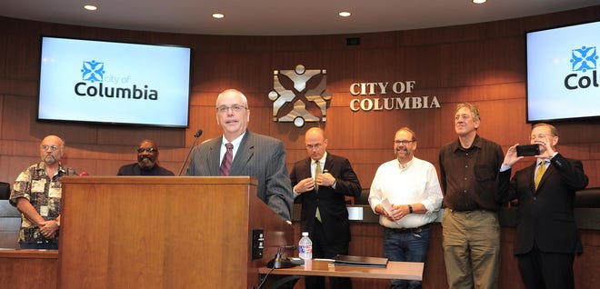 With members of the Columbia City Council arrayed behind him, John Glascock speaks July 15 after being named city manager. [Don Shrubshell/Tribune]