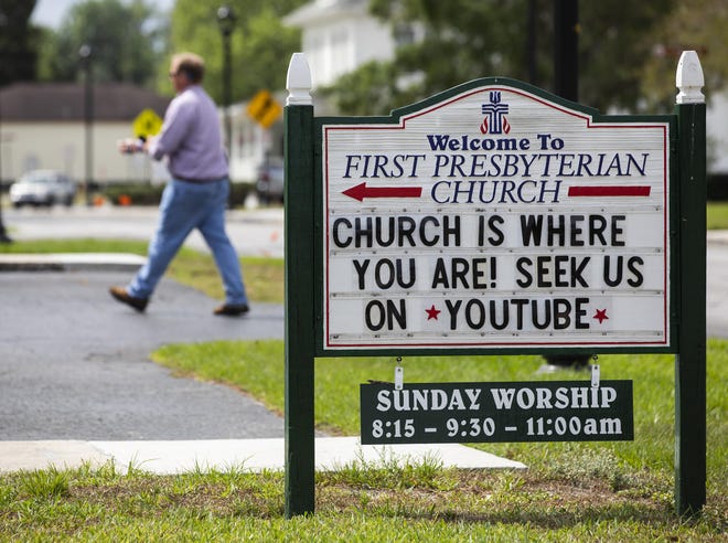A pedestrian makes his way by the marque at the First Presbyterian Church in Ocala on Tuesday. Some churches are holding drive-in service while others are going completely online due to the coronavirus pandemic. [Doug Engle/Staff photographer]
