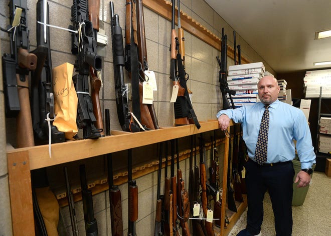 Mike Nolan, deputy chief of criminal investigations with the Erie Bureau of Police, is shown March 10 in an evidence locker at police headquarters. Local police are continuing to work together to get weapons off the streets. [JACK HANRAHAN/ERIE TIMES-NEWS]