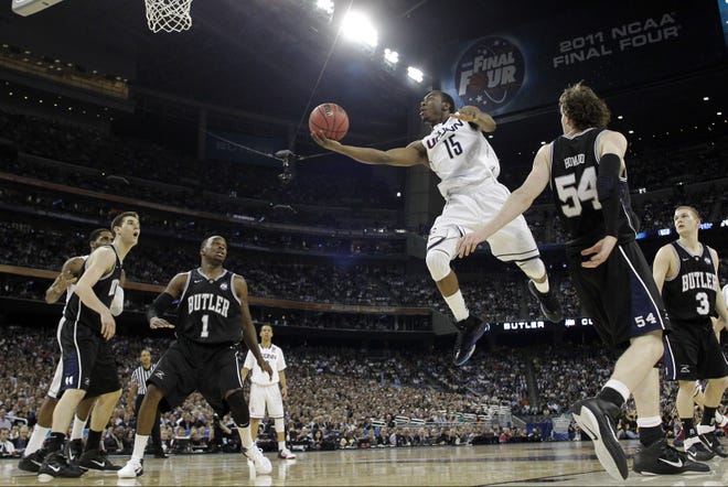 On April 4, 2011, Connecticut's Kemba Walker (top) shoots against Butler during the second half of the men's NCAA championship game in Houston. UConn went on to beat Butler. [AP File Photo/Eric Gay]
