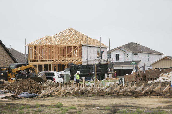 Construction crews work on new homes in a Buda subdivision last year. The market value for Hays County homes is up almost 8%, according to the Hays Central Appraisal District. [BRONTE WITTPENN/AMERICAN-STATESMAN/FILE]